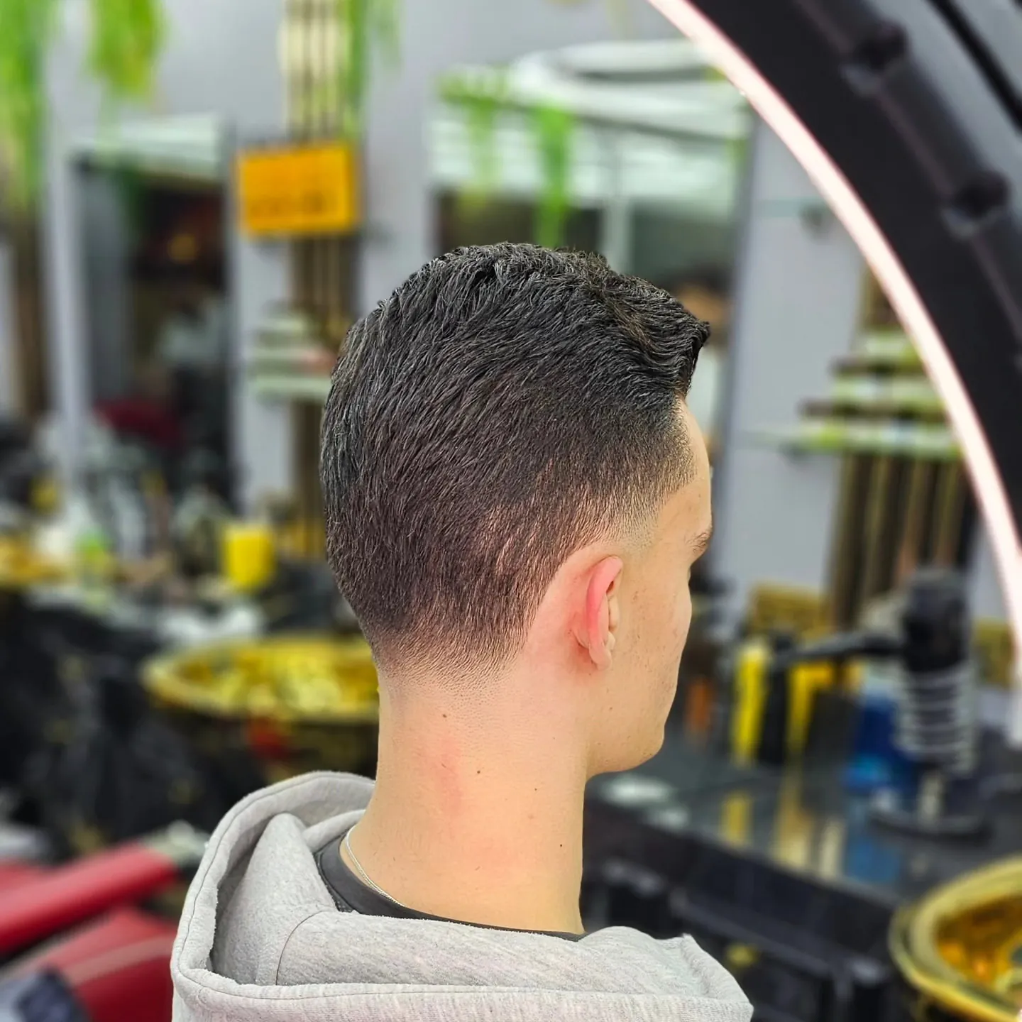 A skin fade from behind, fresh out of the chair